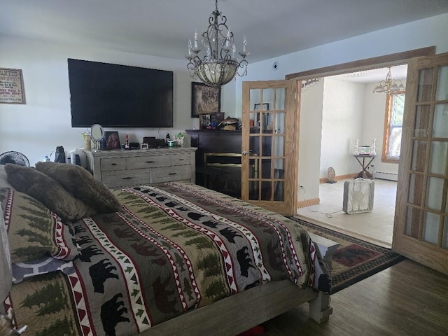 269 Bruckoff Rd, Clifton, ME 04428 - bedroom featuring a chandelier, wood finished floors, baseboard heating, and french doors