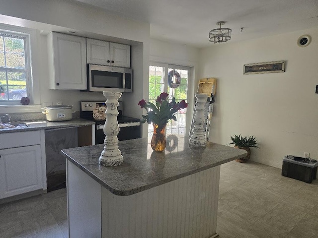 269 Bruckoff Rd, Clifton, ME 04428 - kitchen featuring stainless steel microwave, electric stove, and a center island