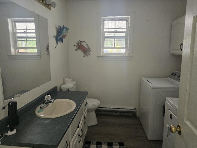 269 Bruckoff Rd, Clifton, ME 04428 - bathroom with separate washer and dryer, a baseboard radiator, vanity, and wood finished floors