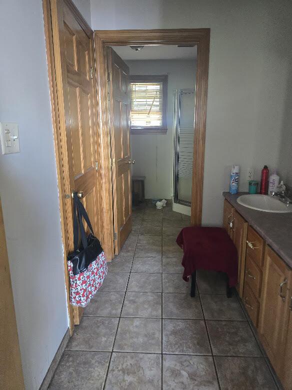 269 Bruckoff Rd, Clifton, ME 04428 - full bathroom with vanity, a shower stall, and tile patterned flooring