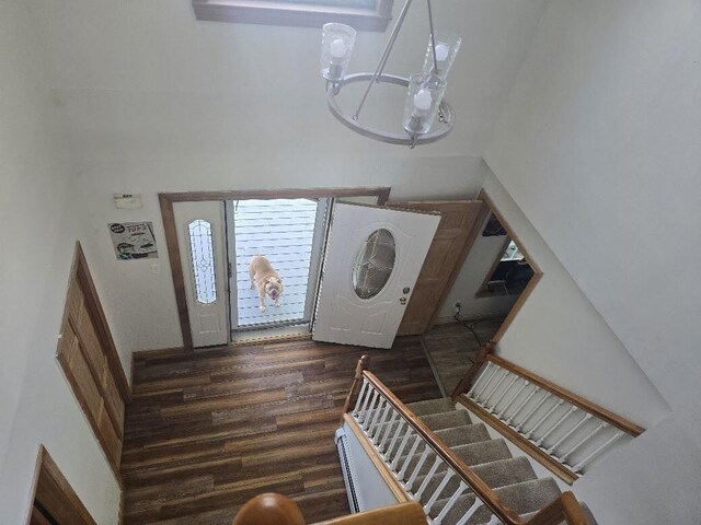 269 Bruckoff Rd, Clifton, ME 04428 - entryway featuring stairs, dark wood-style flooring, and a chandelier