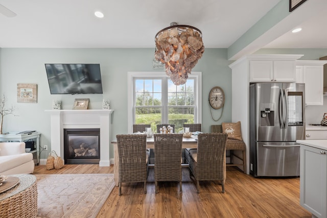 18 Frontier Way Unit 162, Arundel, ME 04046 - dining area with light wood-type flooring, a glass covered fireplace, and recessed lighting