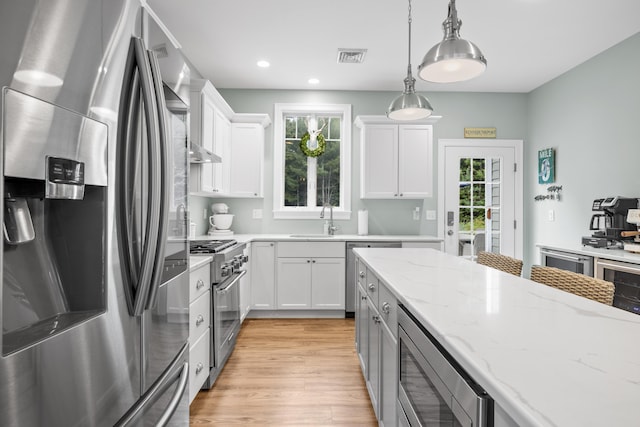 18 Frontier Way Unit 162, Arundel, ME 04046 - kitchen with appliances with stainless steel finishes, healthy amount of natural light, light wood-style floors, white cabinetry, and recessed lighting