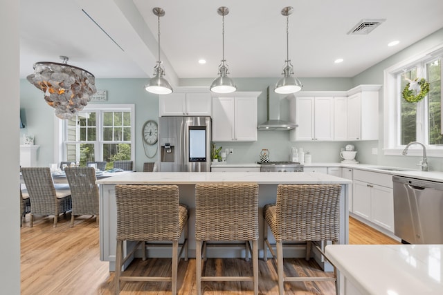 18 Frontier Way Unit 162, Arundel, ME 04046 - kitchen featuring stainless steel appliances, wall chimney exhaust hood, a kitchen island, healthy amount of natural light, and recessed lighting