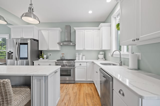 18 Frontier Way Unit 162, Arundel, ME 04046 - kitchen featuring wall chimney exhaust hood, stainless steel appliances, plenty of natural light, white cabinetry, and recessed lighting