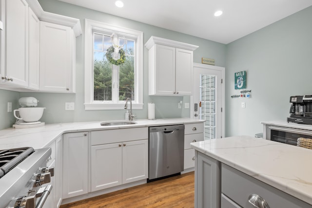 18 Frontier Way Unit 162, Arundel, ME 04046 - kitchen featuring appliances with stainless steel finishes, recessed lighting, white cabinetry, light stone countertops, and light wood-type flooring