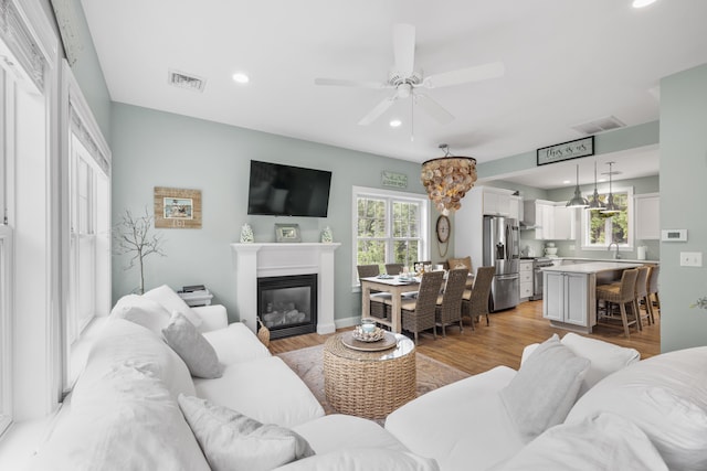 18 Frontier Way Unit 162, Arundel, ME 04046 - living room featuring a ceiling fan, light wood-style floors, recessed lighting, and a glass covered fireplace