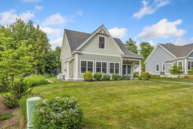 18 Frontier Way Unit 162, Arundel, ME 04046 - back of house featuring a lawn and roof with shingles