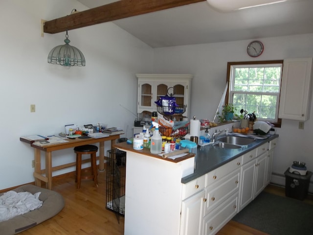 583 River Rd, Calais, ME 04619 - kitchen featuring a peninsula, white cabinets, light wood-style flooring, and dark countertops