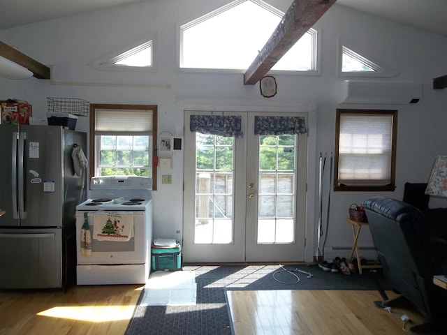 583 River Rd, Calais, ME 04619 - doorway featuring french doors, wood finished floors, a baseboard heating unit, and high vaulted ceiling