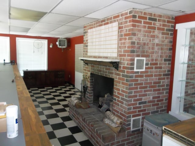 583 River Rd, Calais, ME 04619 - living area with tile patterned floors, a drop ceiling, and a brick fireplace