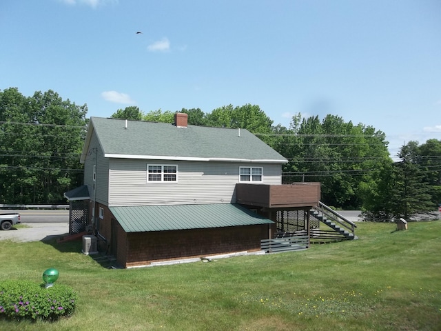 583 River Rd, Calais, ME 04619 - rear view of house with stairs, a yard, and a chimney
