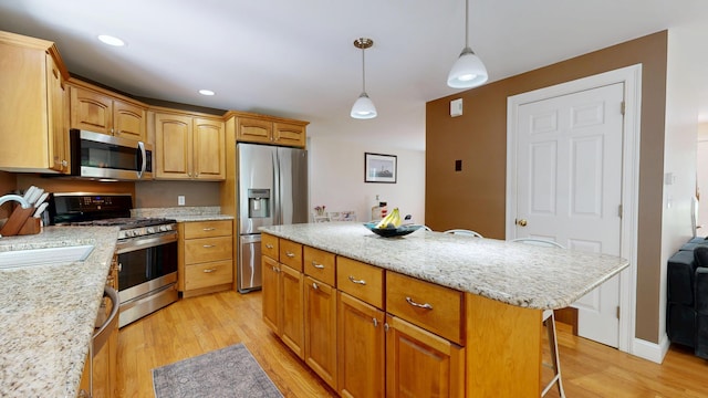 3 Marr Farm Way, Scarborough, ME 04074 - kitchen featuring appliances with stainless steel finishes, light wood-style flooring, a kitchen breakfast bar, a center island, and hanging light fixtures