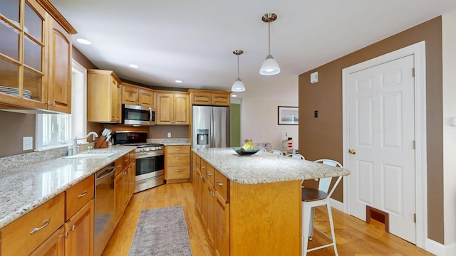 3 Marr Farm Way, Scarborough, ME 04074 - kitchen featuring stainless steel appliances, a center island, a kitchen bar, light wood-style flooring, and glass insert cabinets