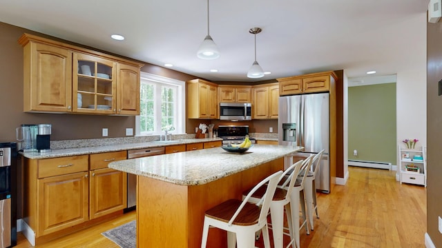 3 Marr Farm Way, Scarborough, ME 04074 - kitchen with appliances with stainless steel finishes, a baseboard heating unit, a center island, glass insert cabinets, and light wood-style flooring