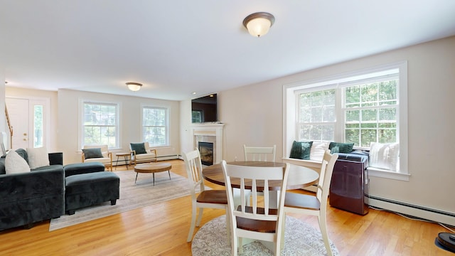 3 Marr Farm Way, Scarborough, ME 04074 - dining space with light wood-style floors, a tiled fireplace, and a baseboard radiator