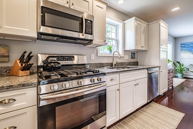 164 State St, Gorham, ME 04038 - kitchen with stainless steel appliances, dark wood-style floors, recessed lighting, white cabinetry, and dark stone countertops