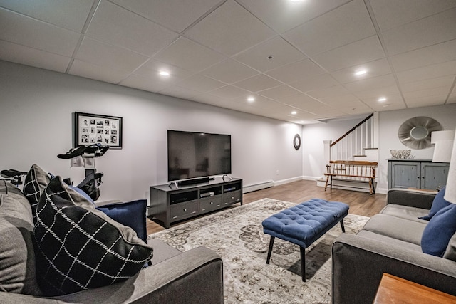 164 State St, Gorham, ME 04038 - living room featuring baseboard heating, stairs, wood finished floors, a drop ceiling, and recessed lighting