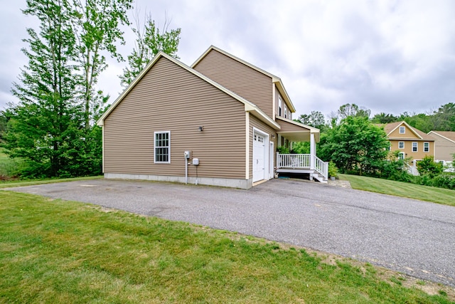 164 State St, Gorham, ME 04038 - view of side of property with asphalt driveway, a lawn, and a garage