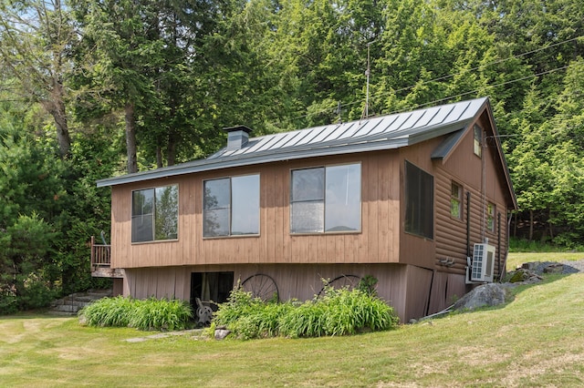 76 Colony Rd, Belgrade, ME 04917 - view of home's exterior with a standing seam roof, a yard, a metal roof, and a chimney