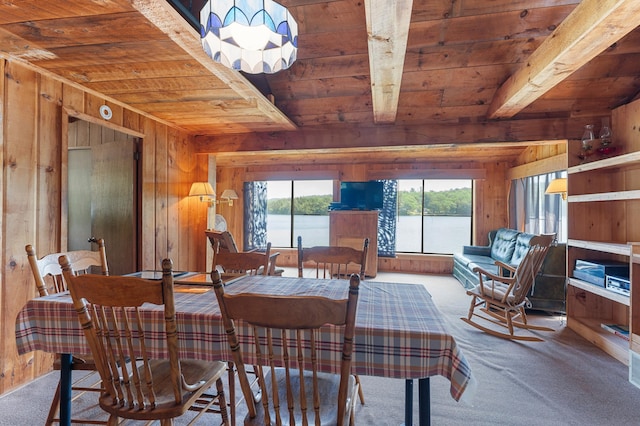76 Colony Rd, Belgrade, ME 04917 - dining room featuring a wood ceiling with exposed beams, wooden walls, carpet floors, and a chandelier