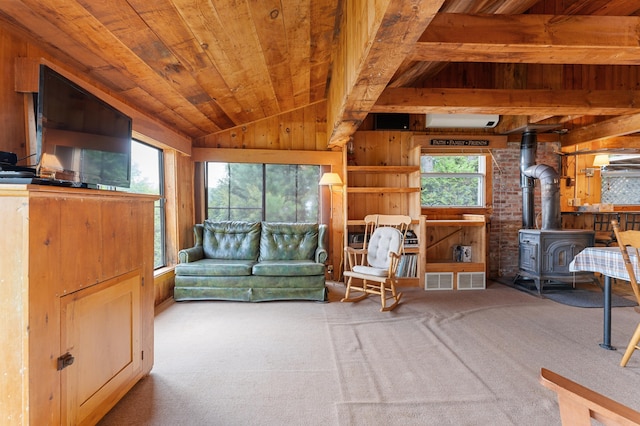 76 Colony Rd, Belgrade, ME 04917 - carpeted living room with wooden walls, a wood stove, wooden ceiling, and a wall unit AC