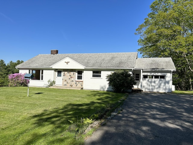 323 Montsweag Rd, Woolwich, ME 04579 - view of front of home with a garage, a chimney, driveway, a front lawn, and roof with shingles
