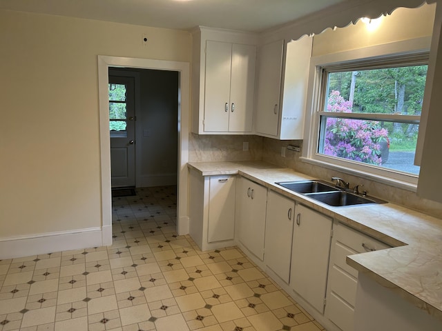 323 Montsweag Rd, Woolwich, ME 04579 - kitchen featuring white cabinets, light countertops, light flooring, and tasteful backsplash