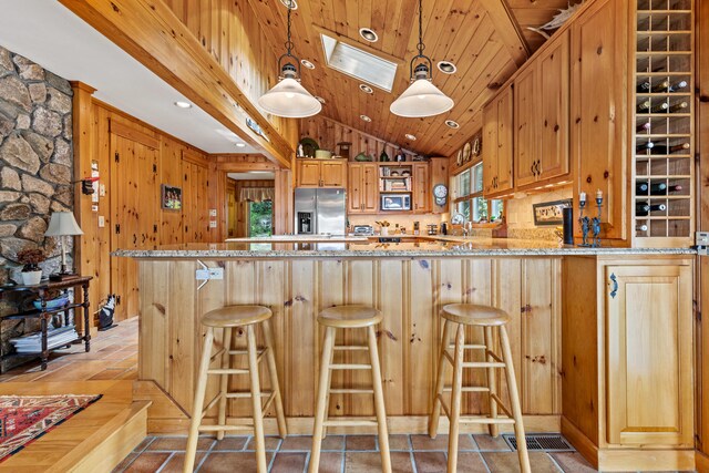 59 Wild Acres Rd, Raymond, ME 04071 - kitchen featuring appliances with stainless steel finishes, plenty of natural light, vaulted ceiling, light stone counters, and wood ceiling