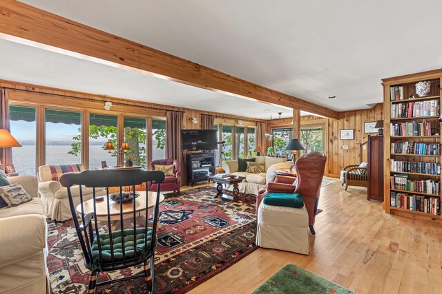 59 Wild Acres Rd, Raymond, ME 04071 - living room with light wood-style floors, healthy amount of natural light, beamed ceiling, and wood walls
