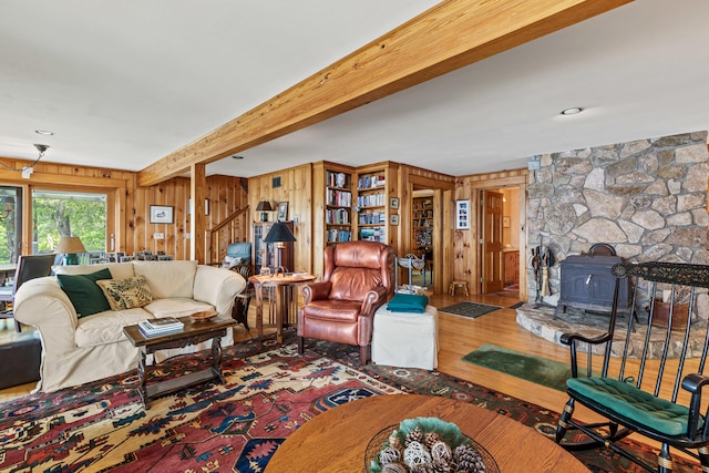 59 Wild Acres Rd, Raymond, ME 04071 - living room featuring wood finished floors, wood walls, a wood stove, and beamed ceiling