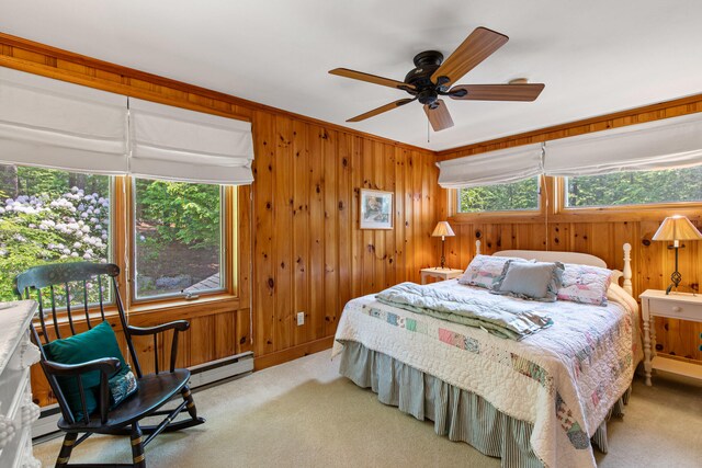 59 Wild Acres Rd, Raymond, ME 04071 - carpeted bedroom with multiple windows, wooden walls, baseboard heating, ceiling fan, and crown molding