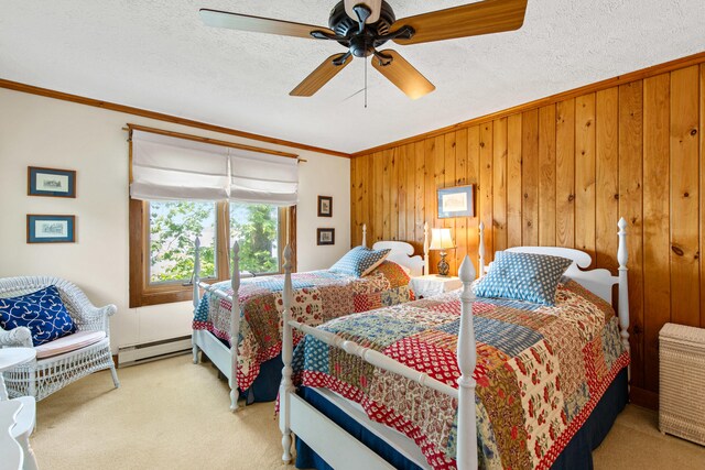 59 Wild Acres Rd, Raymond, ME 04071 - carpeted bedroom with a baseboard heating unit, crown molding, wood walls, a ceiling fan, and a textured ceiling