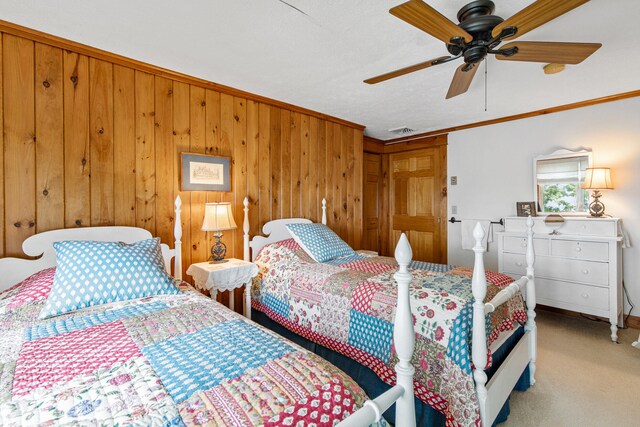 59 Wild Acres Rd, Raymond, ME 04071 - carpeted bedroom with wooden walls, ornamental molding, and ceiling fan