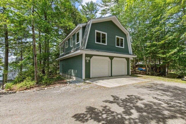 59 Wild Acres Rd, Raymond, ME 04071 - view of side of home with a gambrel roof and a garage
