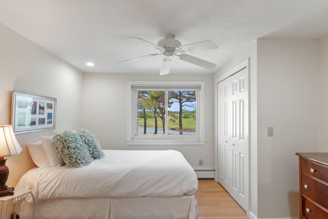 17 White Cap Ln, Wells, ME 04090 - bedroom with a closet, light wood finished floors, baseboard heating, ceiling fan, and recessed lighting