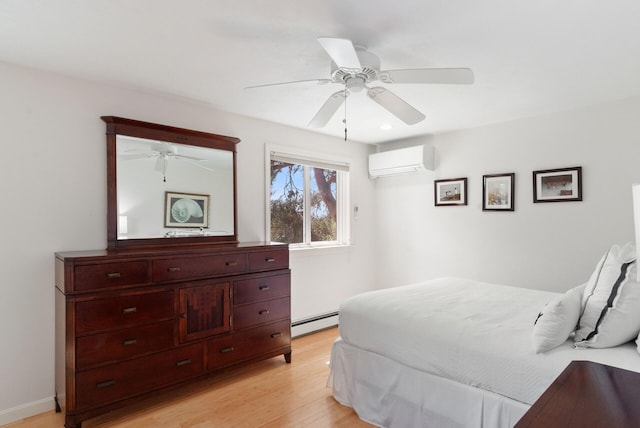 17 White Cap Ln, Wells, ME 04090 - bedroom featuring an AC wall unit, a baseboard radiator, light wood-style floors, and a ceiling fan