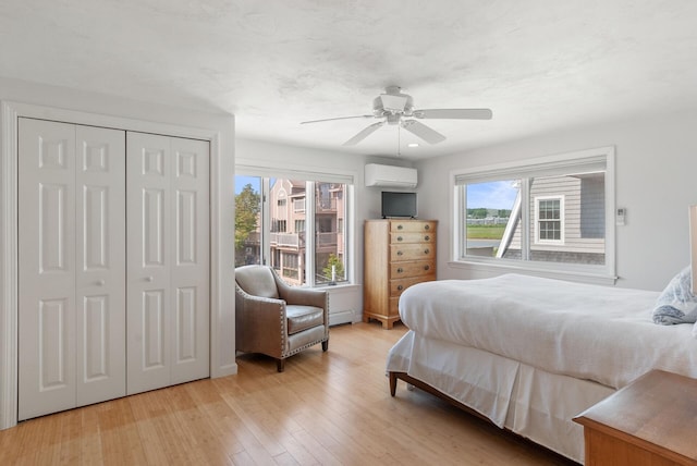17 White Cap Ln, Wells, ME 04090 - bedroom with a wall mounted air conditioner, light wood-style floors, ceiling fan, and a closet