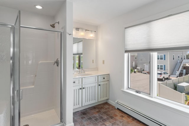 17 White Cap Ln, Wells, ME 04090 - bathroom with baseboard heating, vanity, stone finish flooring, a shower stall, and recessed lighting