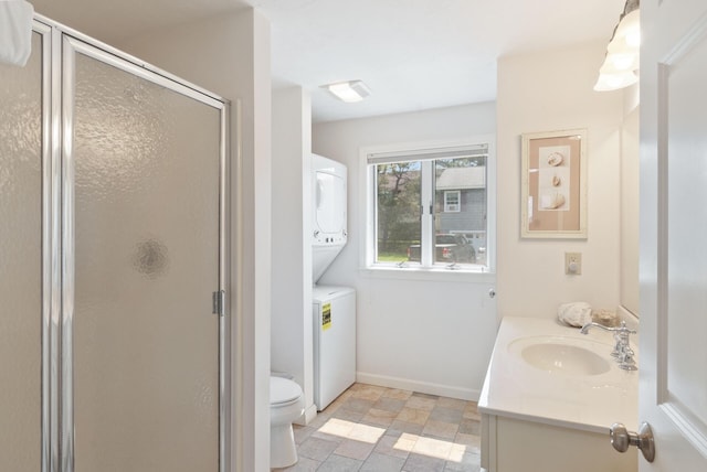 17 White Cap Ln, Wells, ME 04090 - full bathroom featuring stacked washing machine and dryer, vanity, a shower stall, and stone finish flooring