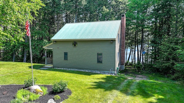 115 Fuller Ln, Denmark, ME 04022 - view of side of property featuring a chimney, a lawn, and a metal roof