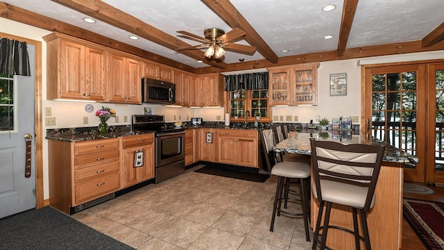 115 Fuller Ln, Denmark, ME 04022 - kitchen with appliances with stainless steel finishes, beam ceiling, a kitchen bar, a ceiling fan, and recessed lighting