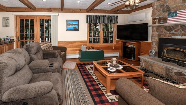 115 Fuller Ln, Denmark, ME 04022 - living area with beamed ceiling, a wall unit AC, ceiling fan, a baseboard radiator, and a wainscoted wall