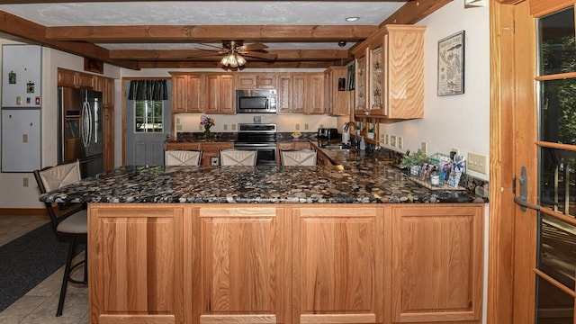 115 Fuller Ln, Denmark, ME 04022 - kitchen featuring appliances with stainless steel finishes, beam ceiling, a peninsula, ceiling fan, and light tile patterned flooring