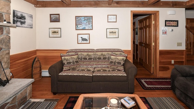 115 Fuller Ln, Denmark, ME 04022 - living area with wainscoting, beamed ceiling, wood finished floors, wooden walls, and baseboard heating