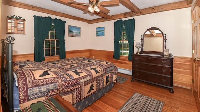 115 Fuller Ln, Denmark, ME 04022 - bedroom featuring wood finished floors, a baseboard heating unit, wainscoting, beamed ceiling, and wood walls