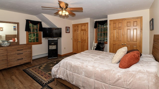 115 Fuller Ln, Denmark, ME 04022 - bedroom with a baseboard radiator, wood finished floors, ceiling fan, and two closets