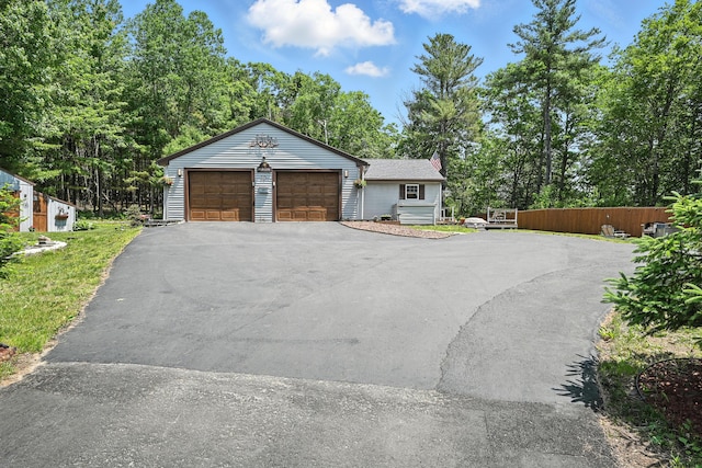 10 Tenacious Way, Augusta, ME 04330 - view of front facade featuring a chimney, asphalt driveway, and view of wooded area