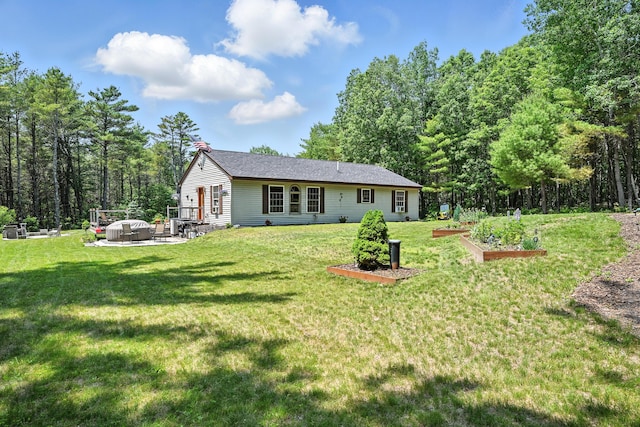 10 Tenacious Way, Augusta, ME 04330 - rear view of house featuring a vegetable garden, a yard, and a patio area