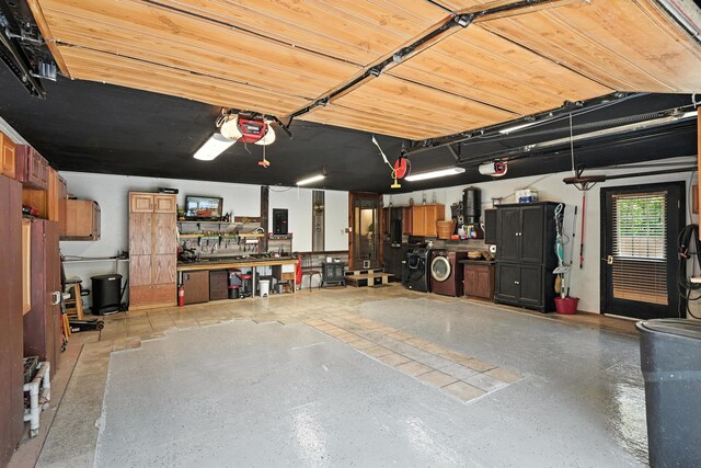 10 Tenacious Way, Augusta, ME 04330 - garage featuring separate washer and dryer, a garage door opener, and a workshop area